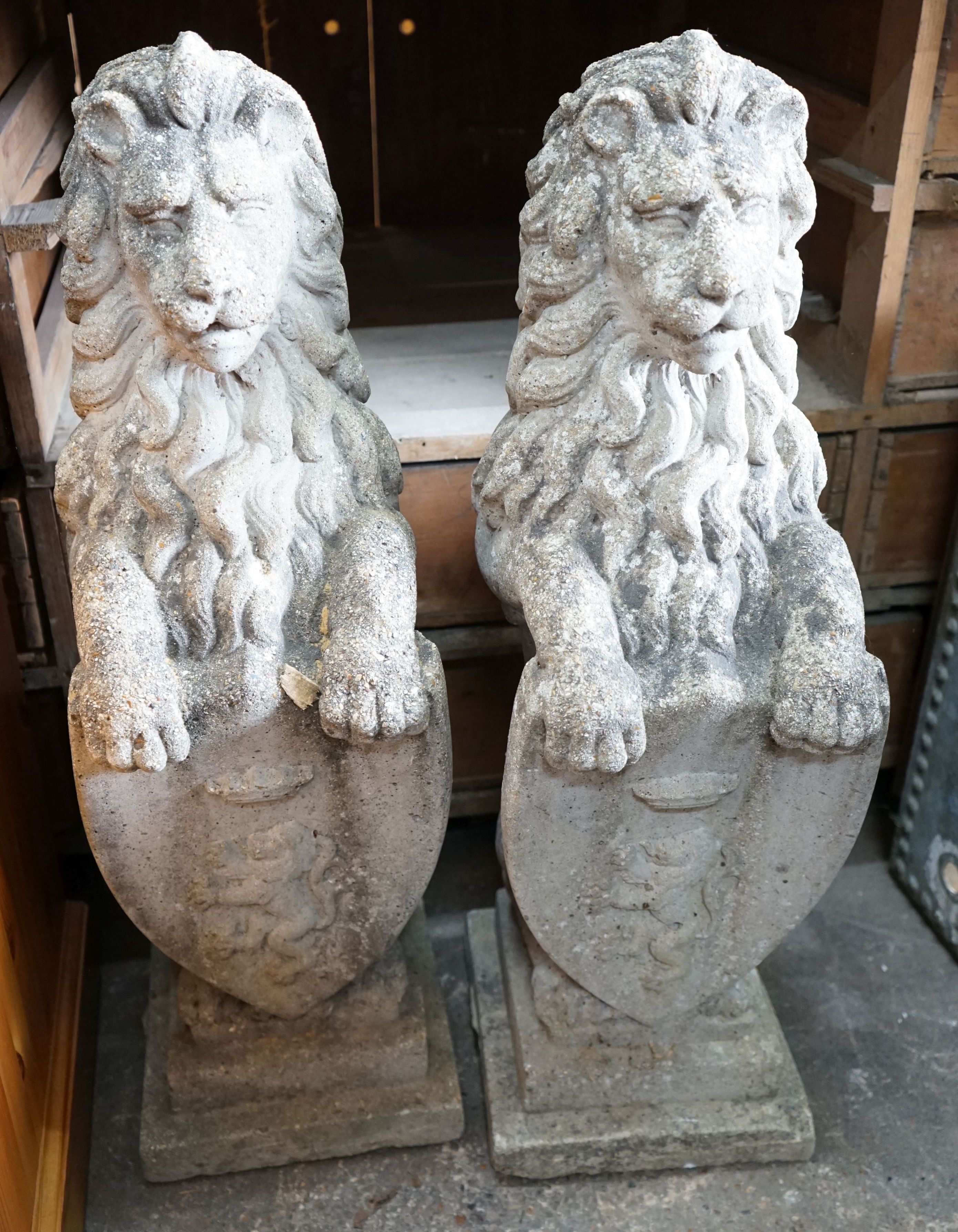 A pair of reconstituted stone heraldic lions, height 80cm